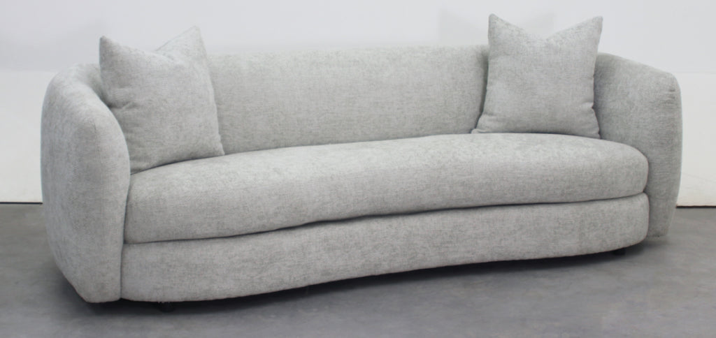 Sofà curvo en tela gris burda